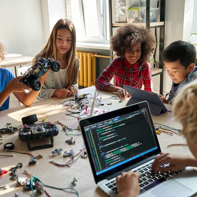 A diverse group of children happily engaging in a STEM class.