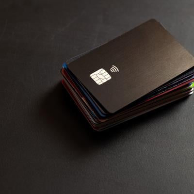 A stack of credit cards in a black background.