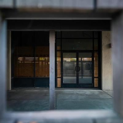 A shuttered door at a homeless shelter in Anaheim that is permanently shut down and partially boarded up.