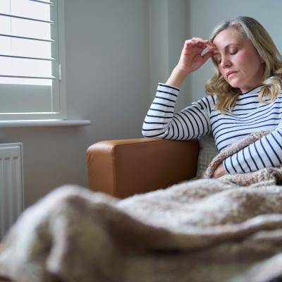 COVID long-hauler feeling unwell and laying on the couch.