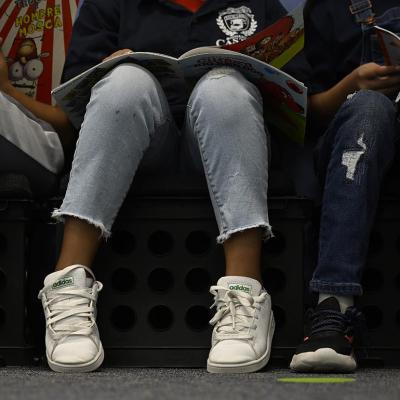 Low angle photo of third-graders reading books in at Castro Elementary.