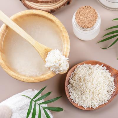 A scoop and bowl of soaked rice for wellness purposes.