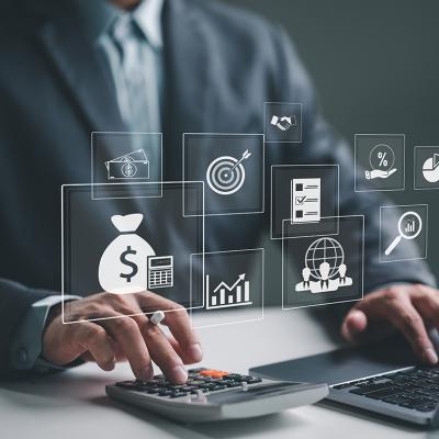 A business employee using a laptop illustrated with holographic concept icons of payroll and expense processes.