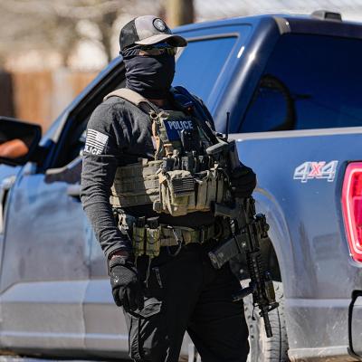 A federal agent identified as ICE conducts raids on a local tire shop business in Colony Ridge on February 24, 2025.