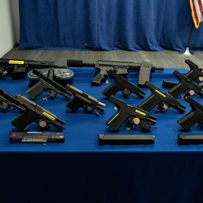 Confiscated guns on display at a press conference.