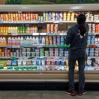 Trader Joe's market dairy aisle being restocked.