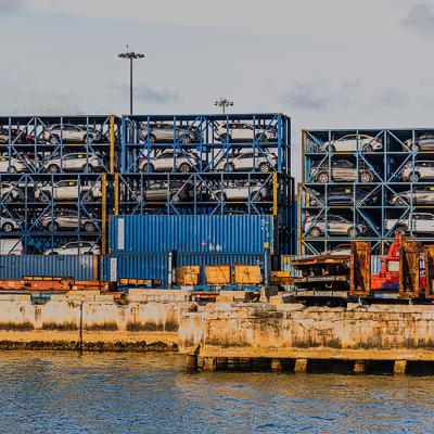Port Miami with imported cars stacked in metal containers.