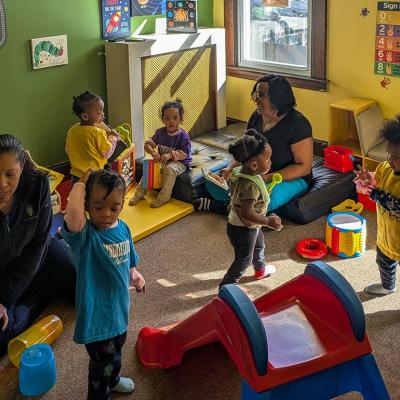 Toddlers play in a colorful room at Sandra Dill’s family child care in a colorful room.