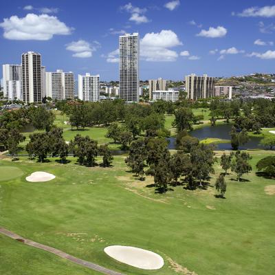 A golf course with condominium buildings overlooking in Hawaii.