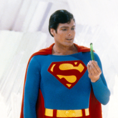 Superman, played by American actor Christopher Reeve (1952 - 2004), holds a green crystal at the Fortress of Solitude, in a promotional still from 'Superman', directed by Richard Donner, 1978.