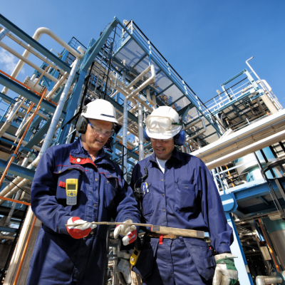 Two workers at an oil refinery plant