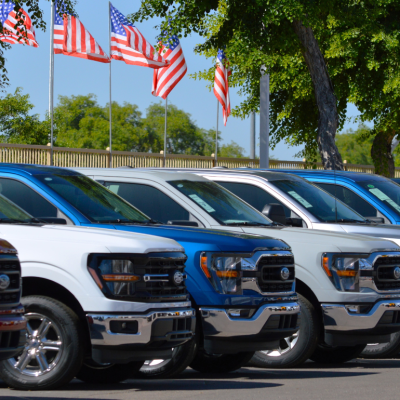 A row of Ford F-150 trucks for sale at a car dealership