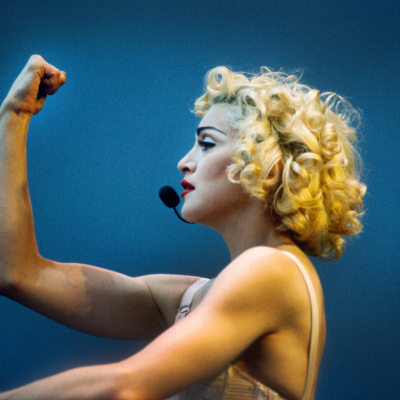 Madonna performing on stage during the Blonde Ambition tour, wearing a Jean Paul Goltier conical bra corset