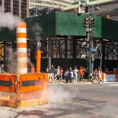 A steam pipe vent and scaffolding on the streets of New York City