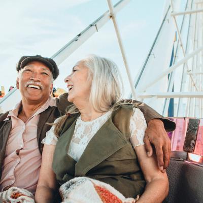 Cheerful senior couple enjoying a ferris wheel by the Santa Monica pier.