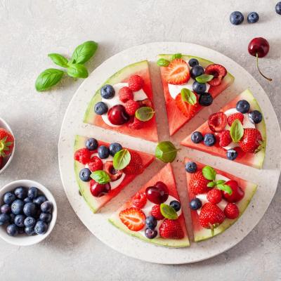 Watermelon pizza slices with yogurt and berries.