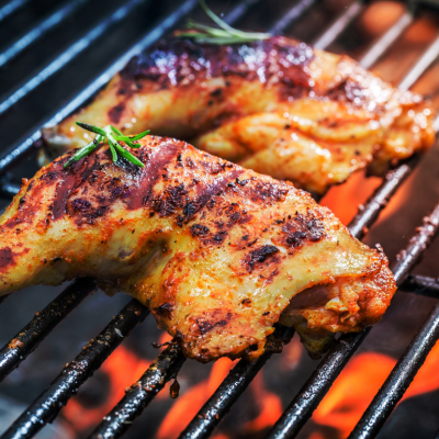 Roasted chicken legs on a hot grill 