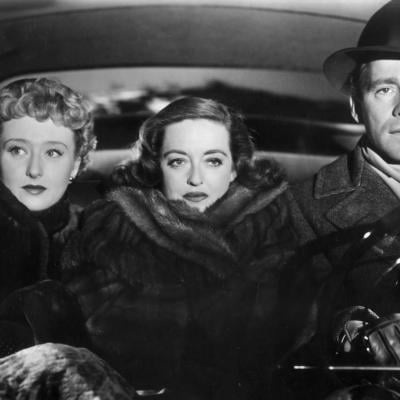Celeste Holm, Bette Davis, and Hugh Marlowe take a bumpy car ride together in the 1950 film 'All About Eve.'