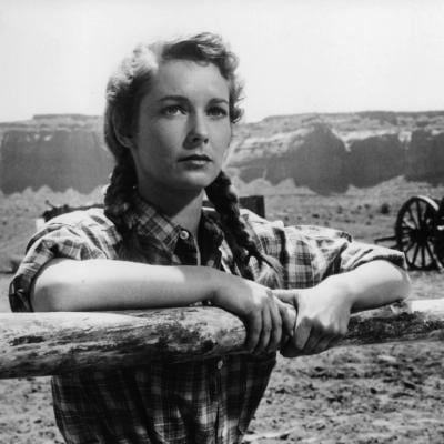 Vera Miles holds onto a wooden fence in a scene from the 1956 film 'The Searchers.'
