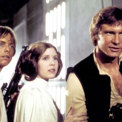 Actors Mark Hamill, Carrie Fisher, and Harrison Ford in the 1977 movie 'Star Wars: Episode IV - A New Hope.'