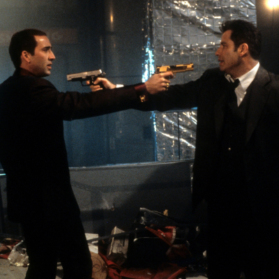 Nicolas Cage and John Travolta aiming guns at each other in a scene from the film 'Face/Off', 1997.