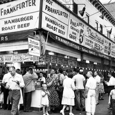 A large crowd orders and eats hotdogs outside the original Nathans Famous Hot Dog stand in Coney Island, Brooklyn, New York, August 6, 1947. 