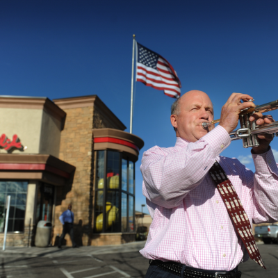 Chick-fil-A Inc. chairman Dan Cathy, son of the chain's founder Truett Cathy, sounds the trumpet while visiting one of his franchises