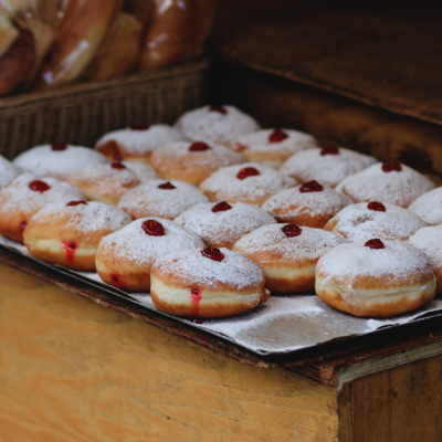 A baking tray full of freshly made sufganiyot