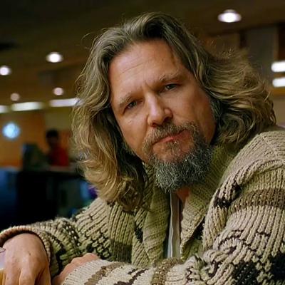 Jeff Bridges as The Big Lebowski sitting in the bowling alley
