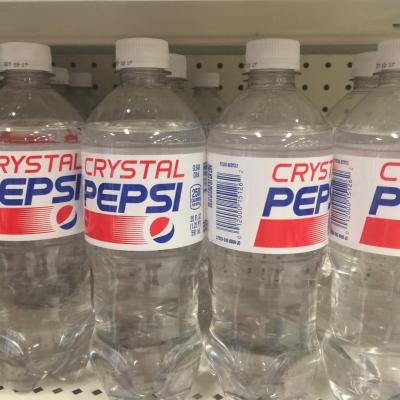 Crystal Pepsi plastic soda bottles on the store shelves for sale.