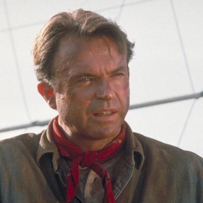 Actor Sam Neill as Dr. Alan Grant, next to an electric fence in a scene from the film 'Jurassic Park', 1993.