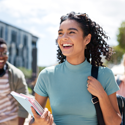 Smiling college students walking on campus.