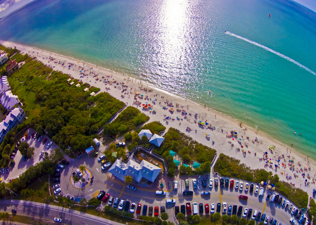 An aerial view of a crowded beach in Bonita Springs, FL.
