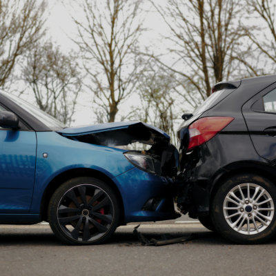 A close up of two cars crashed in an accident.