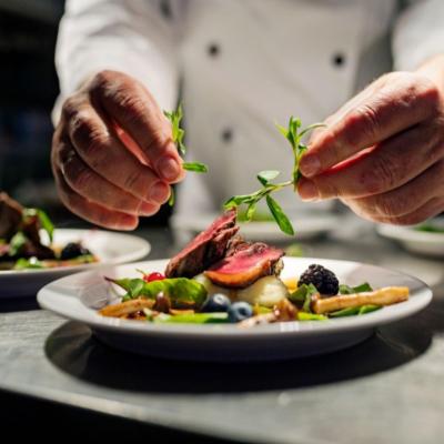 A chef plating a colorful dish.