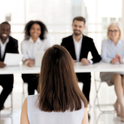 An applicant is interviewed by a board of four HR professionals.