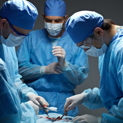 A closeup of surgeons in an operating room performing a surgery.
