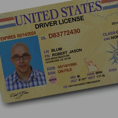 A close-up of the United States driving license with a photo of a man on a yellow background on the left side, his name Robert Jason Blum, expiration date, ID number, address, sex, hair, eyes, height and class.