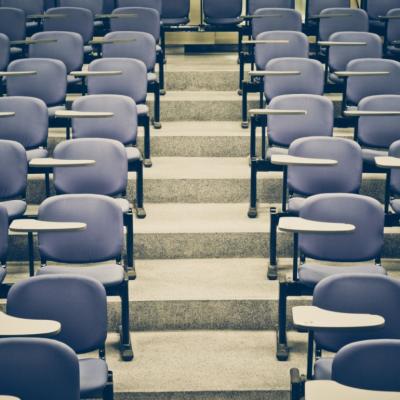Empty blue seats in a lecture room.