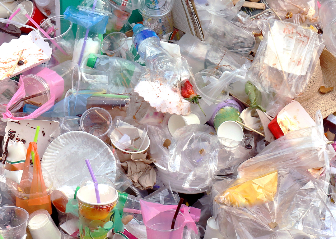 Pile of plastic bottles, bags and packages in a landfill.