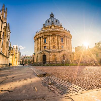 Radcliffe square with the Science Library and sunset flare in Oxford, England.