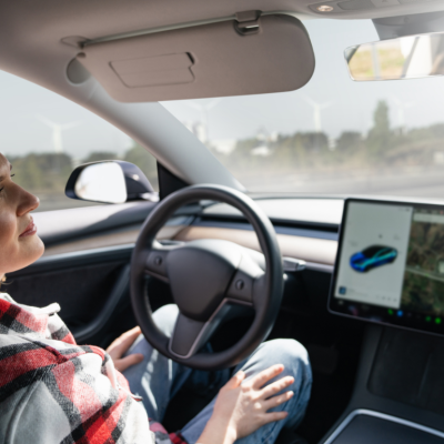 A person relaxing in their self-driving car.