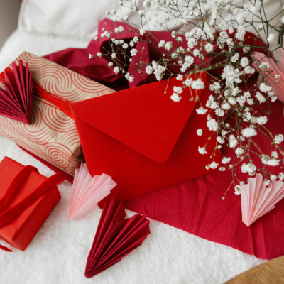 Wrapped gifts, a red envelope, and white flowers.