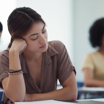 A woman falling asleep in a class.