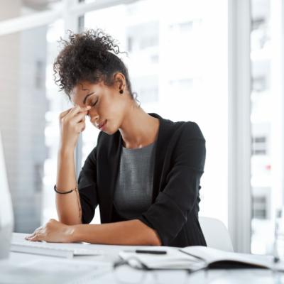 A stressed woman at a desk.