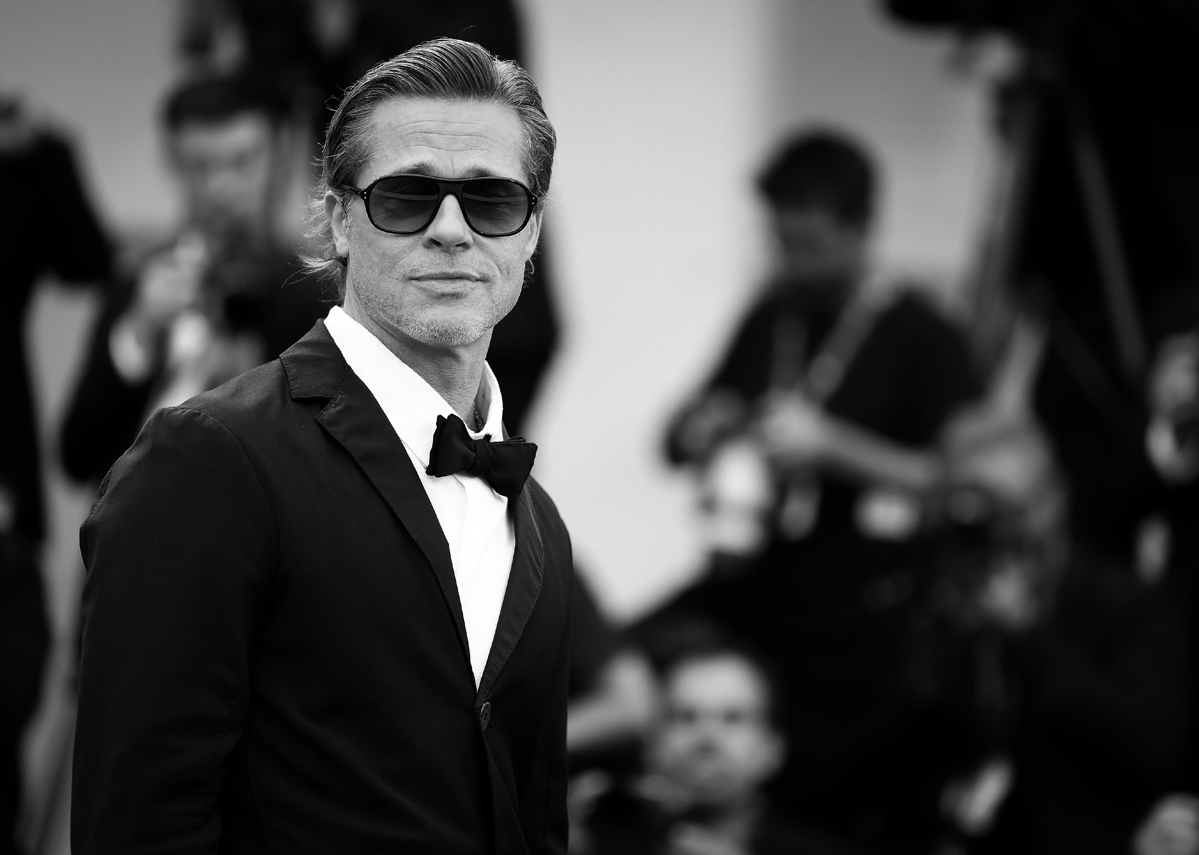 Brad Pitt in a black suit and bowtie.