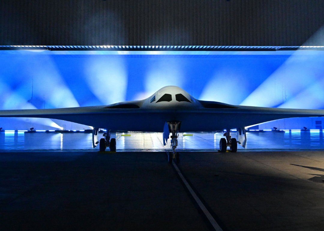 The B-21 Raider Stealth Bomber on display with blue lights.