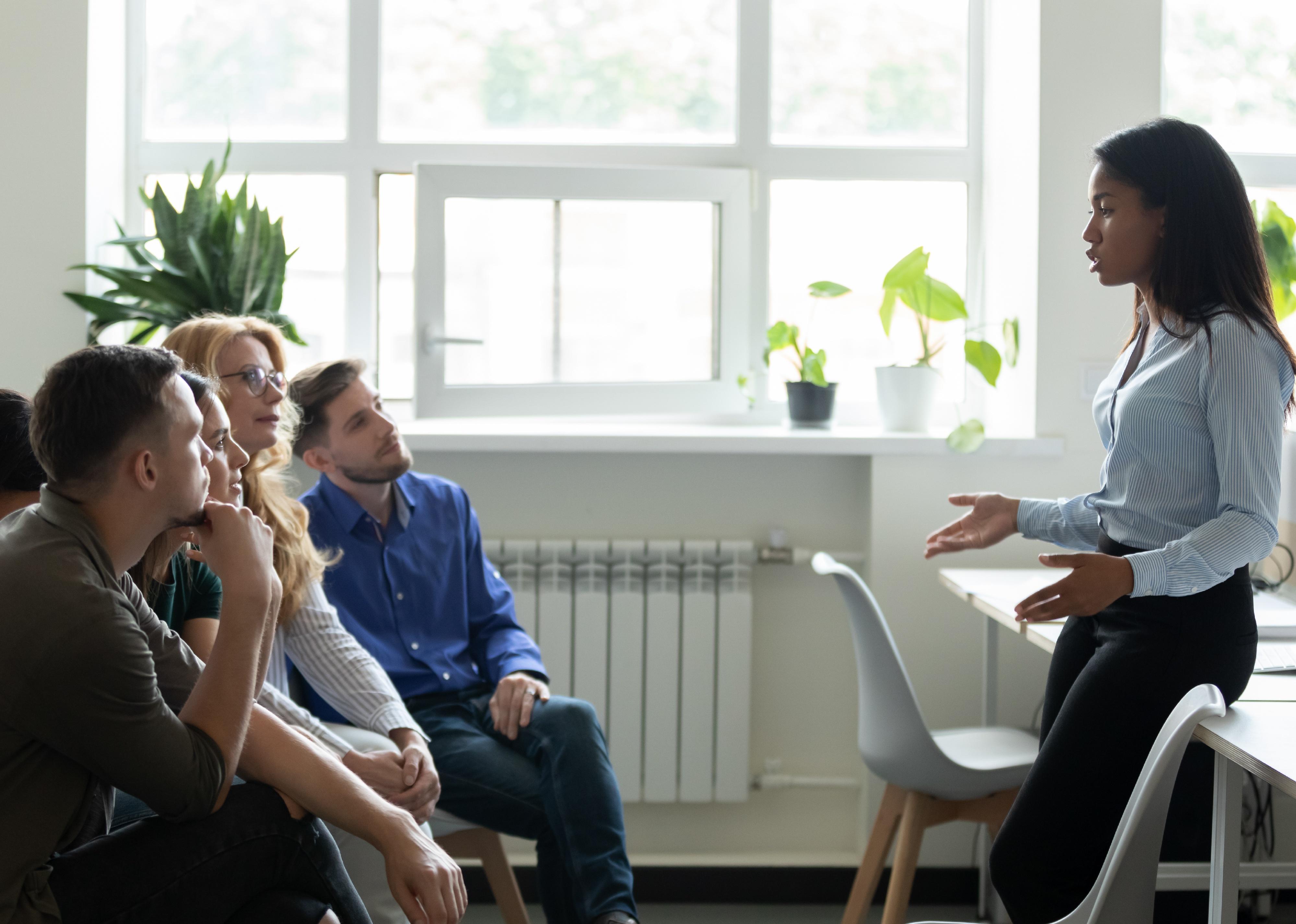 A woman leadig a training for a group of employees.