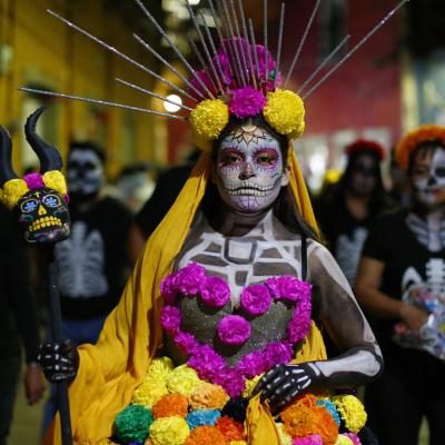 A woman dressed as a catrina during the parade of the "Day Of The Dead Festival" in Guanajuato.