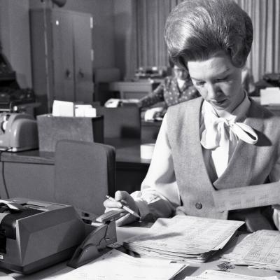 1960s Female office worker working at desk